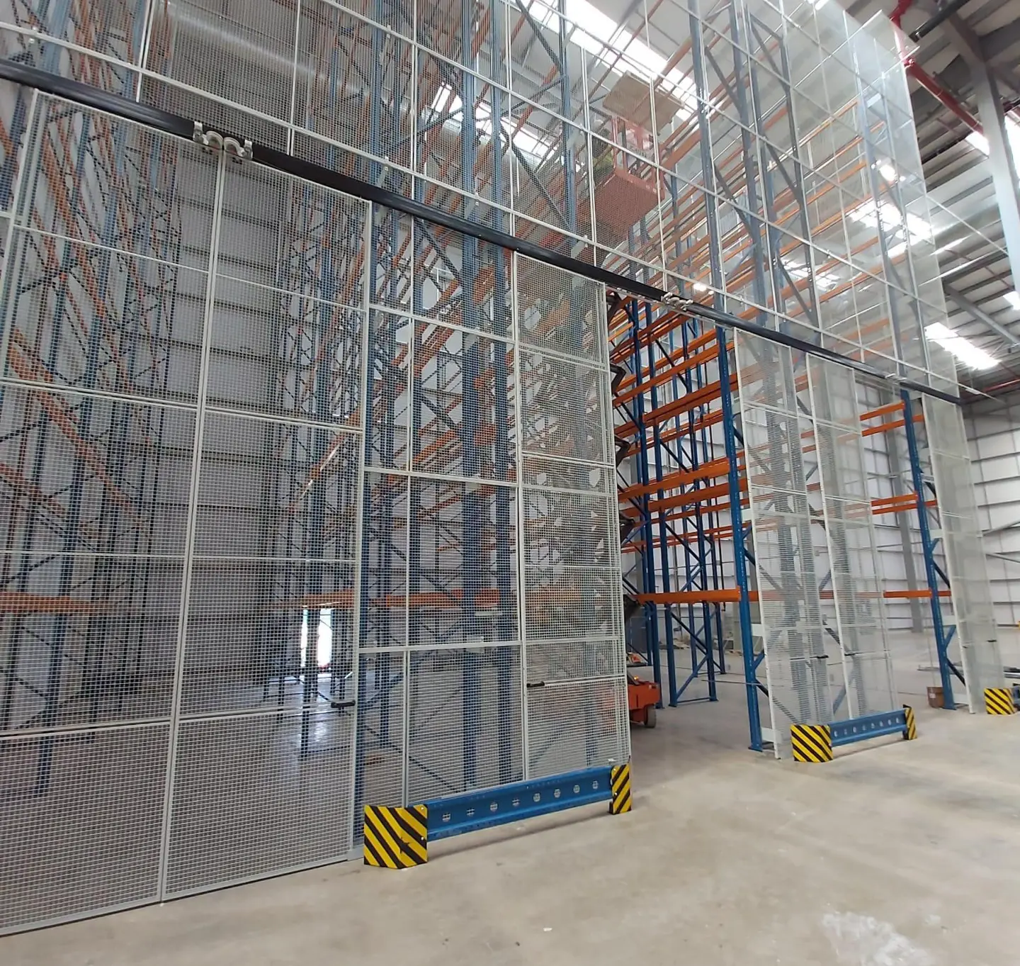 Warehouse mesh partitioning secure storage cage installation