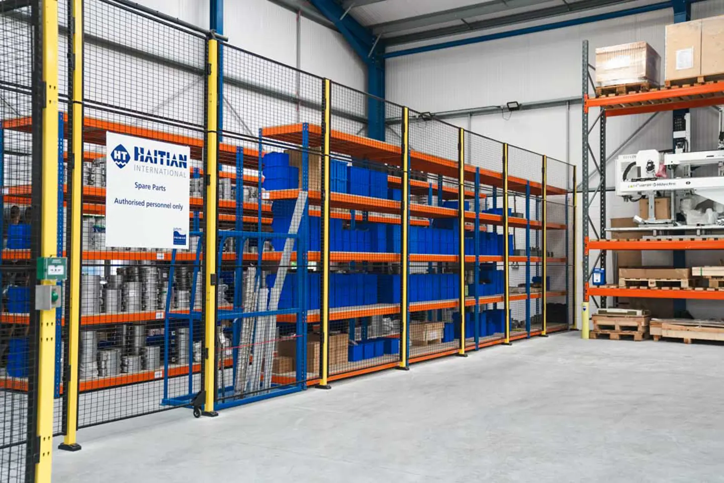 Warehouse stores area secured by tall Axelent machine guard fencing and door