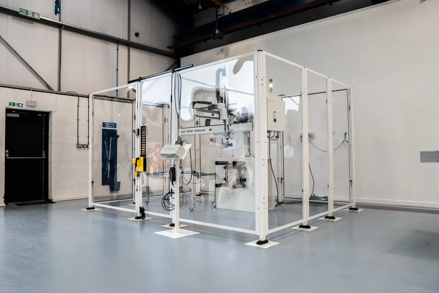 Machine enclosed by Axelent polycarbonate see through panels in all white finish