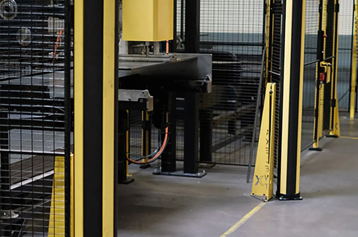Warehouse safety barriers and machine guarding protecting pedestrian walkways around automated conveyor and robotic systems