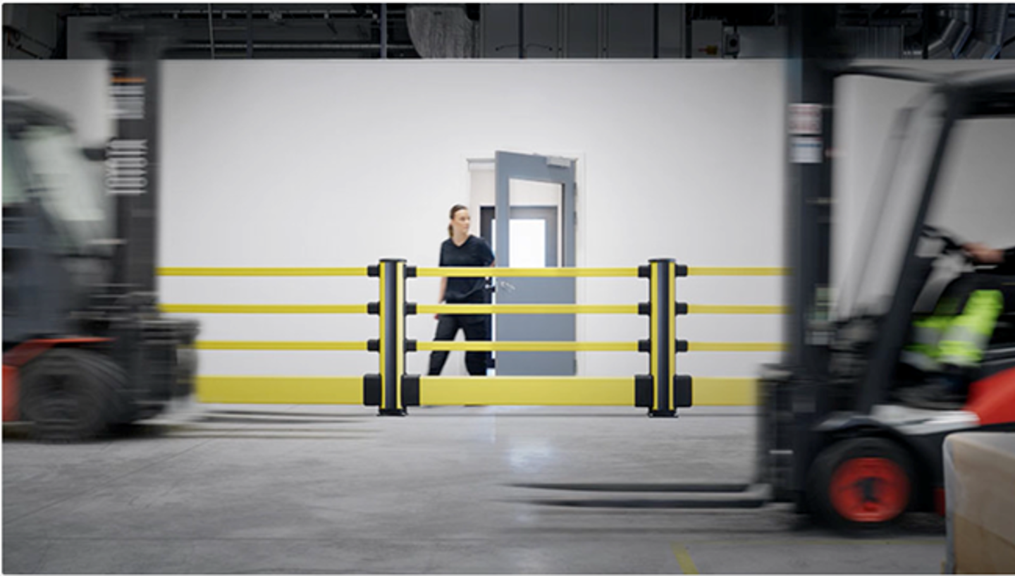 Person protected by polymer impact barriers in busy warehouse enviroment