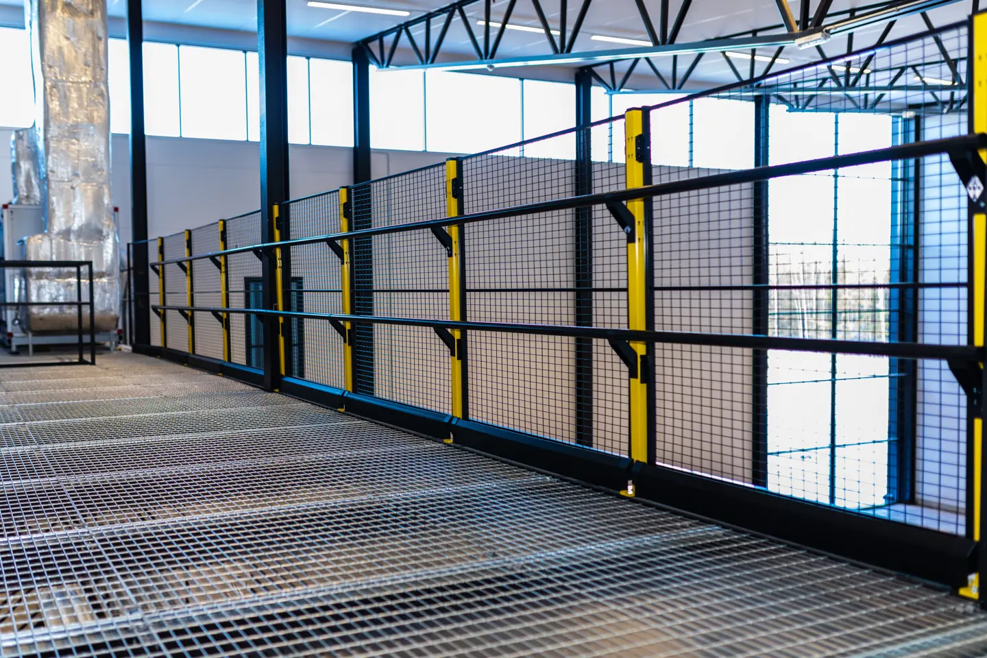Depiction of fall protection handrail system for mezzanine edge