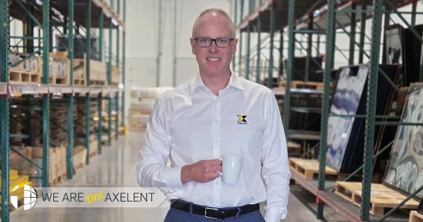 Oskar Berg CEO of Axelent USA stands in a warehouse with his dog