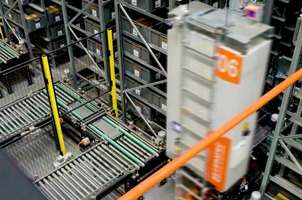Automated warehouse with conveyor belts and a fast-moving storage robot between tall racks of bins