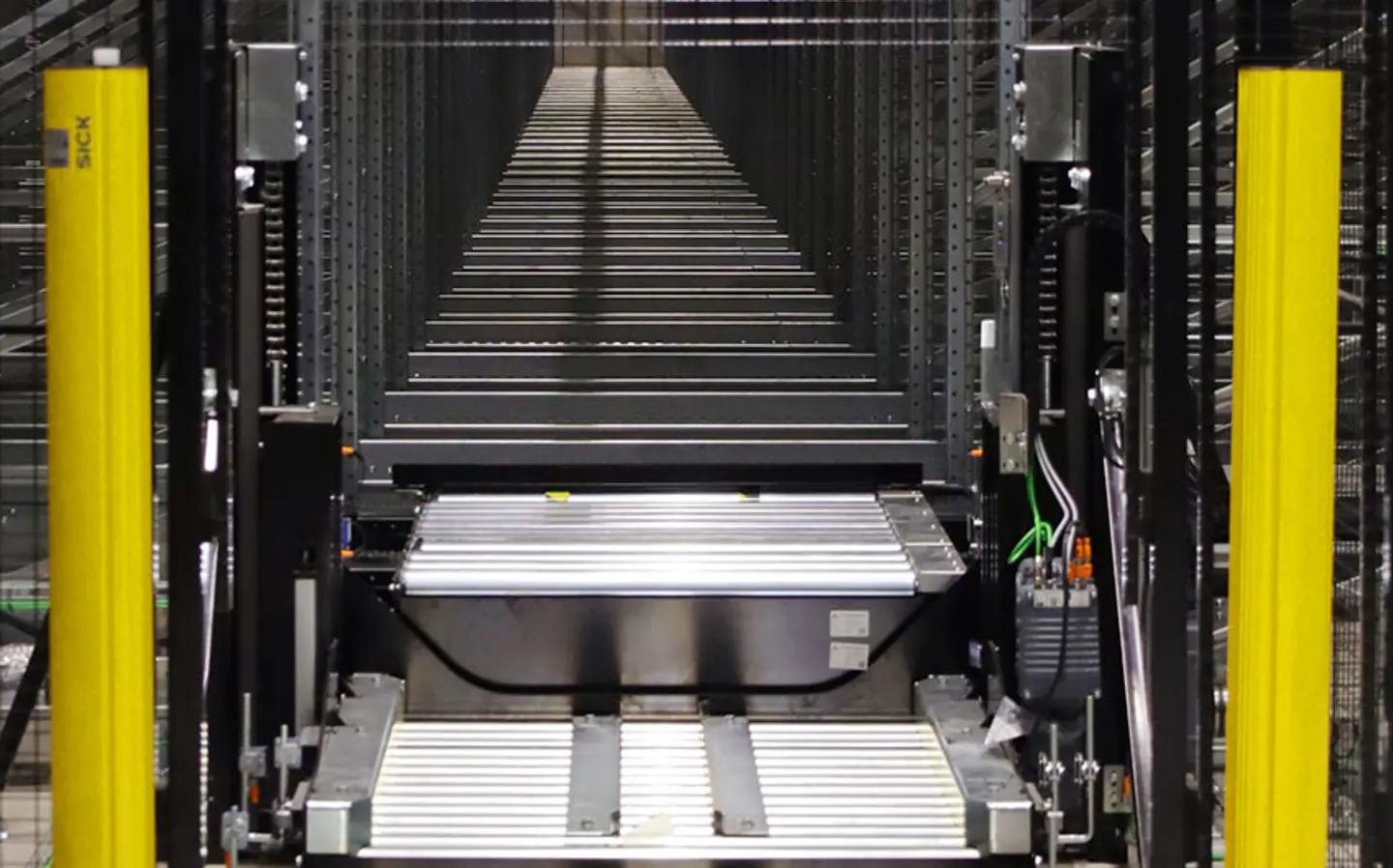 A goods entrace conveyor to an automated storage system is shown with safety fencing and light curtains