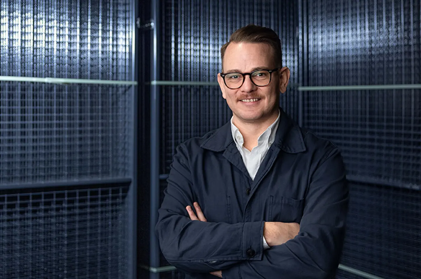 Daniel Häggström chief product offer at Axelent stood in front of mesh panels.